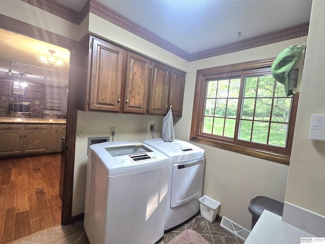 1924 W 8th Ave, Plattsmouth, NE 68048 - laundry area with cabinet space, washer and clothes dryer, baseboards, and crown molding
