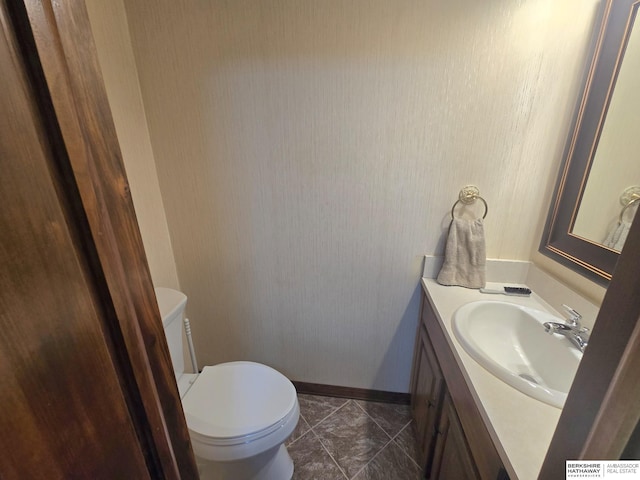 1924 W 8th Ave, Plattsmouth, NE 68048 - bathroom featuring vanity, toilet, and baseboards