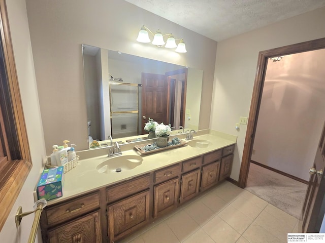 1924 W 8th Ave, Plattsmouth, NE 68048 - bathroom featuring double vanity, a textured ceiling, a stall shower, toilet, and tile patterned flooring
