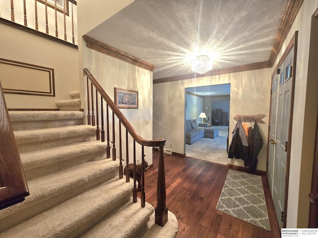 1924 W 8th Ave, Plattsmouth, NE 68048 - stairs with wood-type flooring, crown molding, baseboards, and a chandelier