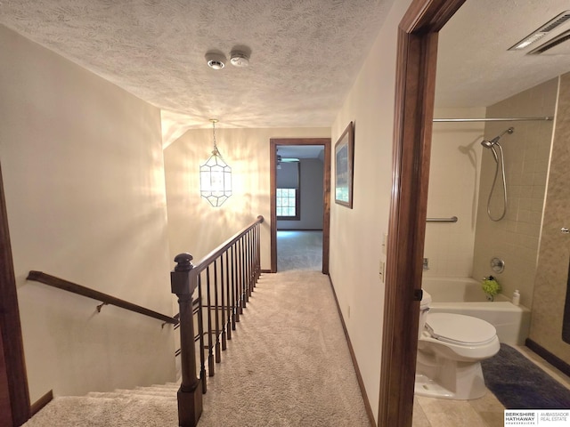 1924 W 8th Ave, Plattsmouth, NE 68048 - bathroom with toilet, shower / bath combination, a textured ceiling, and baseboards