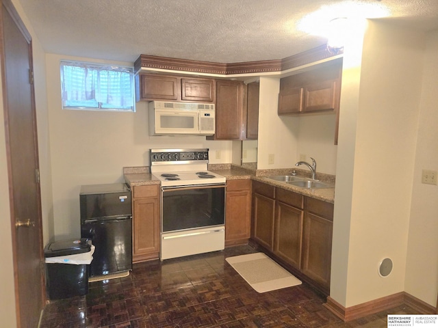1924 W 8th Ave, Plattsmouth, NE 68048 - kitchen with white appliances, a sink, a textured ceiling, and brown cabinets