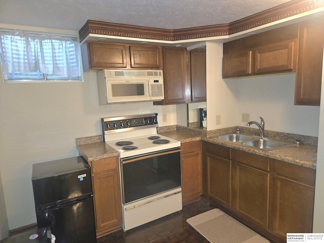 1924 W 8th Ave, Plattsmouth, NE 68048 - kitchen with white appliances, a sink, and a textured ceiling