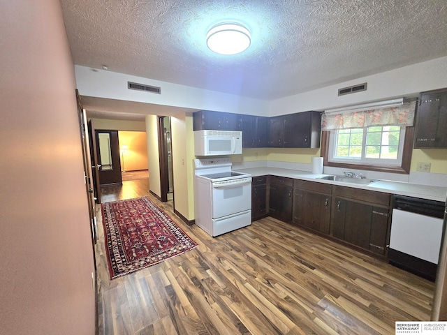1924 W 8th Ave, Plattsmouth, NE 68048 - kitchen with white appliances, a textured ceiling, wood finished floors, a sink, and light countertops