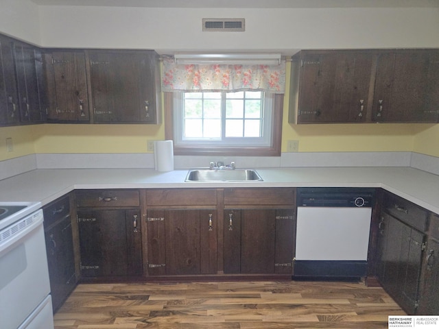 1924 W 8th Ave, Plattsmouth, NE 68048 - kitchen featuring white appliances, a sink, dark brown cabinetry, light countertops, and dark wood-style flooring