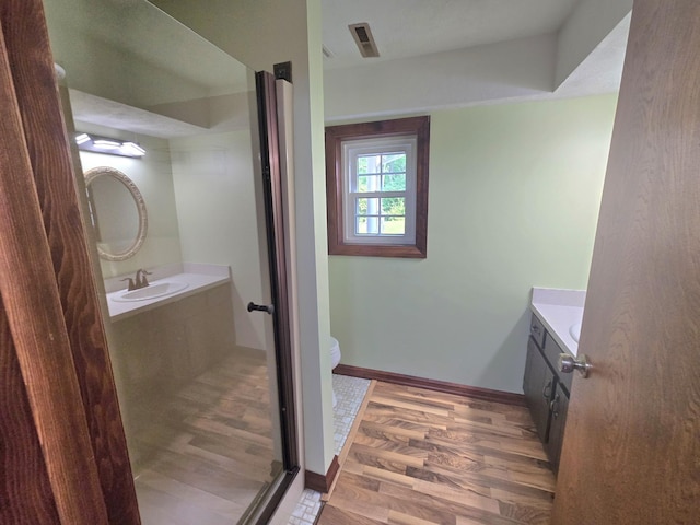 1924 W 8th Ave, Plattsmouth, NE 68048 - bathroom featuring vanity, toilet, wood finished floors, and baseboards