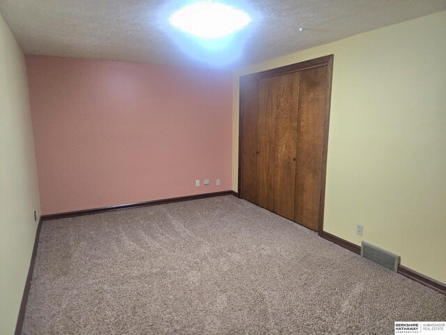 1924 W 8th Ave, Plattsmouth, NE 68048 - unfurnished bedroom featuring carpet floors, a closet, and baseboards