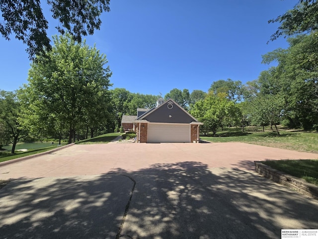 1924 W 8th Ave, Plattsmouth, NE 68048 - garage featuring driveway and view of wooded area