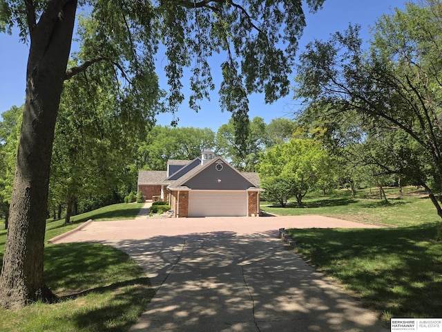 1924 W 8th Ave, Plattsmouth, NE 68048 - view of front of home featuring brick siding, an attached garage, driveway, and a front yard