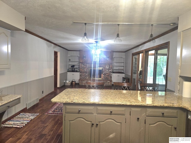 1924 W 8th Ave, Plattsmouth, NE 68048 - kitchen featuring dark wood finished floors, crown molding, a fireplace, wainscoting, and light stone counters