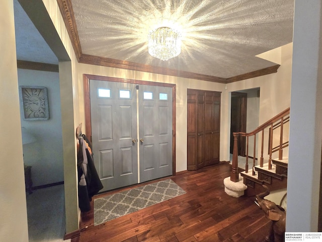 1924 W 8th Ave, Plattsmouth, NE 68048 - entrance foyer featuring a chandelier, dark wood-type flooring, stairway, and crown molding