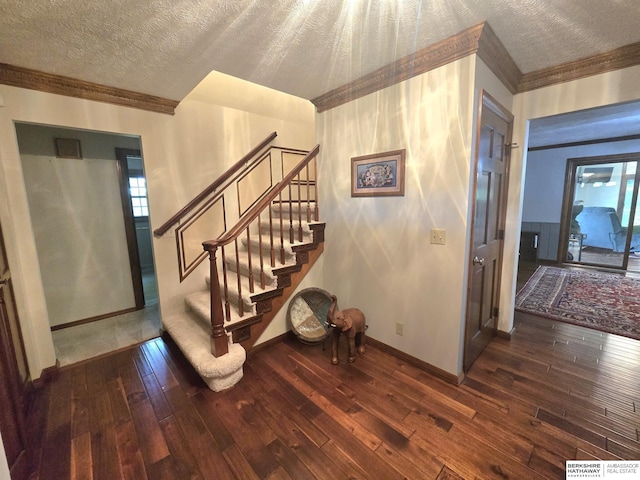 1924 W 8th Ave, Plattsmouth, NE 68048 - stairs with crown molding, hardwood / wood-style floors, a textured ceiling, and baseboards