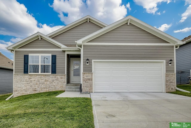 4411 Schilling Dr, Bellevue, NE 68123 - view of front facade with stone siding, concrete driveway, a front yard, and an attached garage