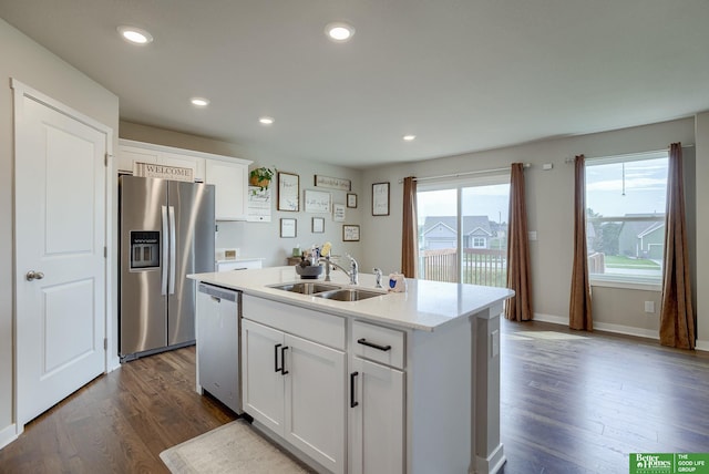4411 Schilling Dr, Bellevue, NE 68123 - kitchen featuring stainless steel appliances, a sink, dark wood finished floors, white cabinets, and a center island with sink