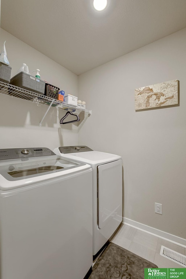 4411 Schilling Dr, Bellevue, NE 68123 - laundry area with washer and dryer, baseboards, and light tile patterned floors