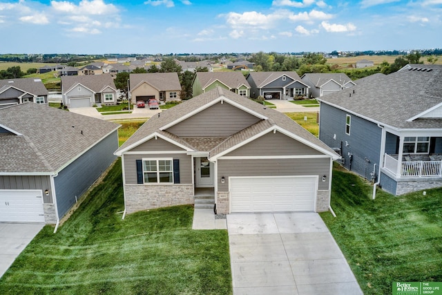 4411 Schilling Dr, Bellevue, NE 68123 - view of front of home with stone siding, a residential view, driveway, a garage, and a front yard