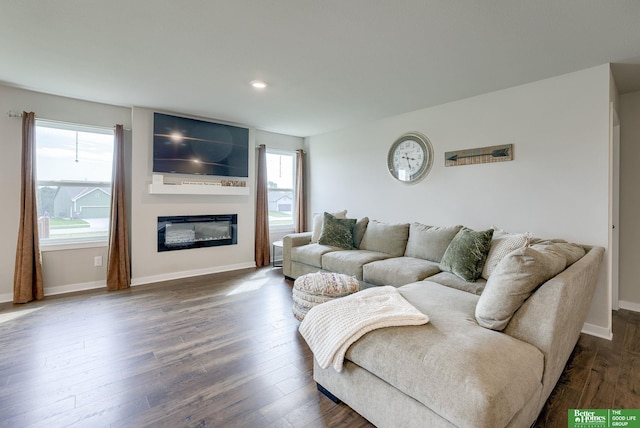 4411 Schilling Dr, Bellevue, NE 68123 - living area featuring plenty of natural light, baseboards, dark wood finished floors, a glass covered fireplace, and recessed lighting