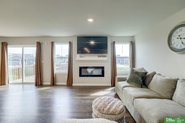4411 Schilling Dr, Bellevue, NE 68123 - living area featuring a glass covered fireplace, wood finished floors, baseboards, and recessed lighting