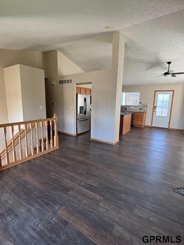 2110 Herel St, Lincoln, NE 68512 - unfurnished living room with baseboards, dark wood-style floors, a ceiling fan, and lofted ceiling