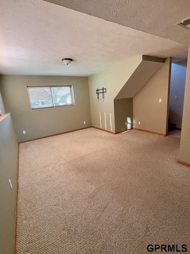 2110 Herel St, Lincoln, NE 68512 - bonus room with light carpet, baseboards, and a textured ceiling