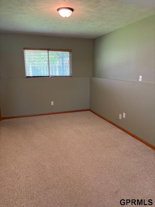 2110 Herel St, Lincoln, NE 68512 - empty room with carpet, a textured ceiling, and baseboards