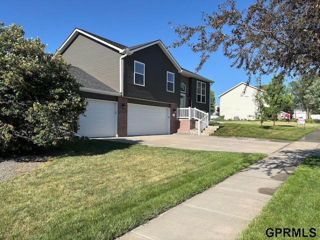 2110 Herel St, Lincoln, NE 68512 - raised ranch with a garage, a front yard, driveway, and brick siding