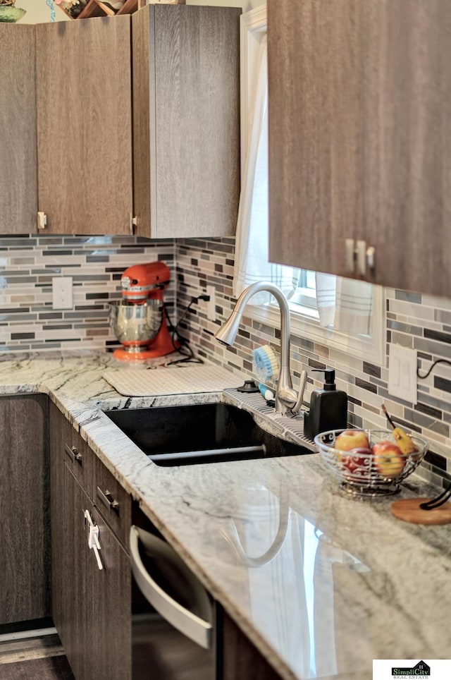 1946 Eastgate Dr, Crete, NE 68333 - kitchen with dishwashing machine, a sink, tasteful backsplash, light stone countertops, and dark brown cabinetry