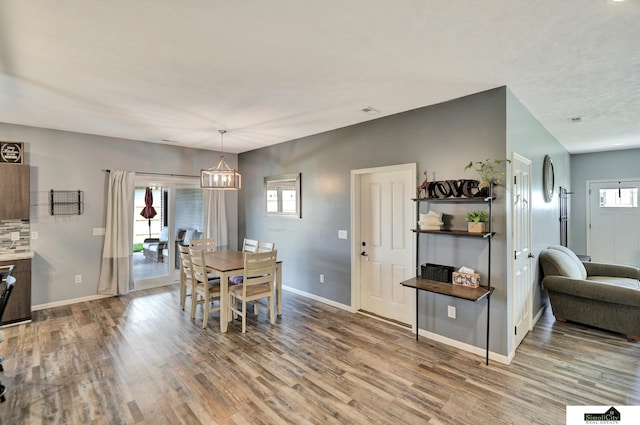 1946 Eastgate Dr, Crete, NE 68333 - dining space with wood finished floors, a chandelier, and baseboards