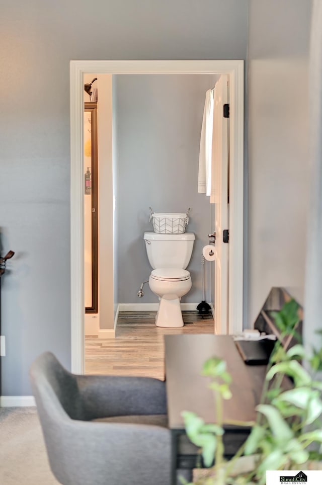 1946 Eastgate Dr, Crete, NE 68333 - bathroom featuring toilet, baseboards, and wood finished floors