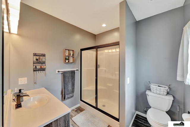 1946 Eastgate Dr, Crete, NE 68333 - full bath featuring a stall shower, baseboards, toilet, wood finished floors, and recessed lighting