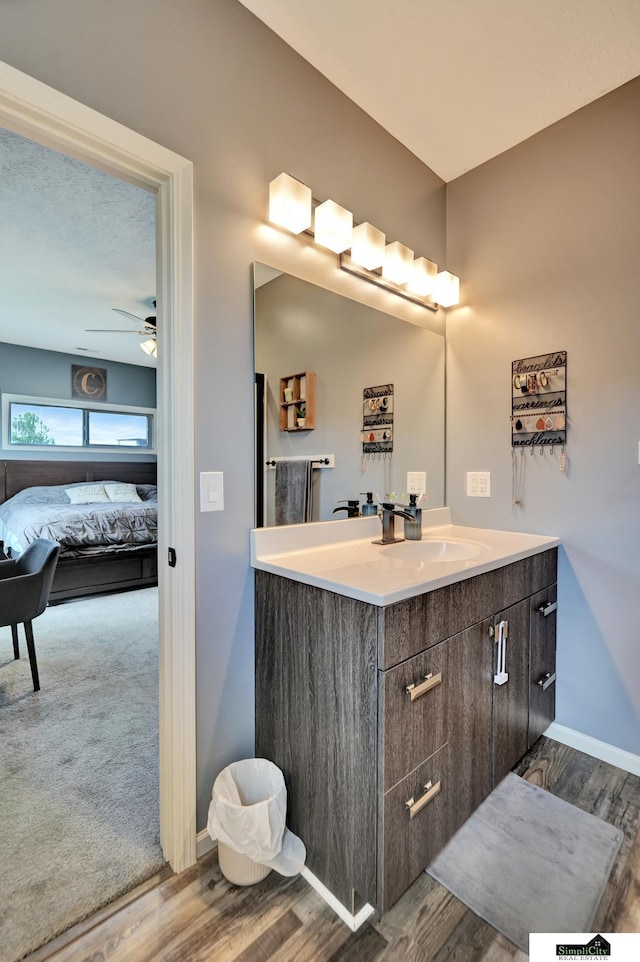 1946 Eastgate Dr, Crete, NE 68333 - ensuite bathroom featuring vanity, wood finished floors, baseboards, and a ceiling fan