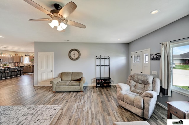 1946 Eastgate Dr, Crete, NE 68333 - living area with wood finished floors, plenty of natural light, recessed lighting, baseboards, and ceiling fan