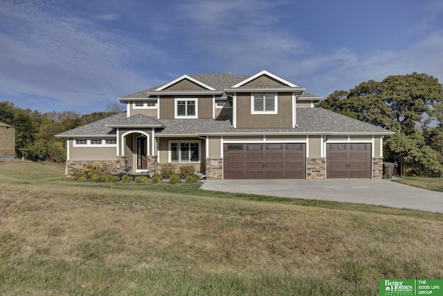 view of front of property with stone siding, driveway, a front yard, and a garage