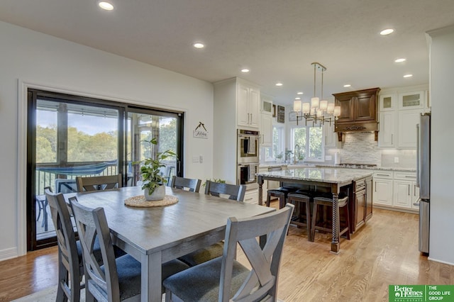 dining area featuring light wood-style flooring and recessed lighting