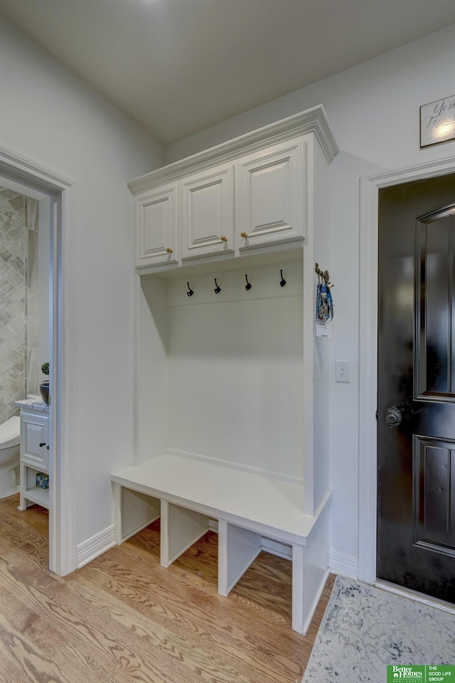 mudroom featuring light wood-style floors and baseboards