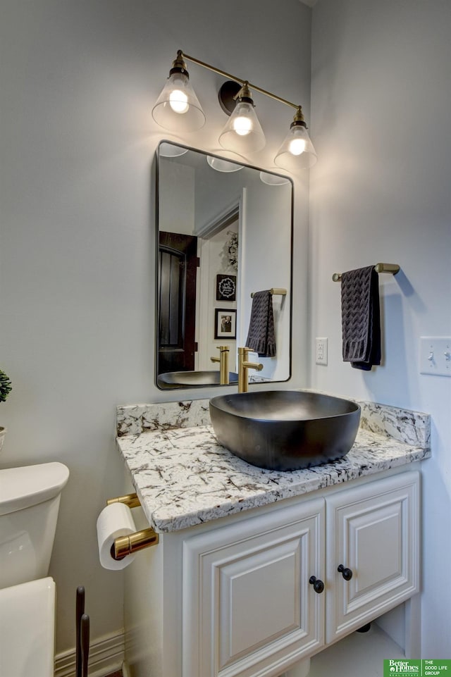 bathroom with toilet and vanity