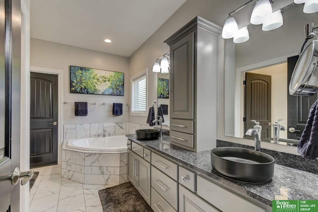 bathroom with marble look tile flooring, a bath, double vanity, and recessed lighting