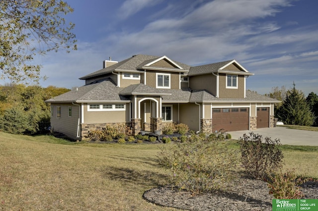 craftsman inspired home with stone siding, driveway, a front yard, and roof with shingles