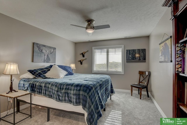 bedroom with carpet, baseboards, a ceiling fan, and a textured ceiling