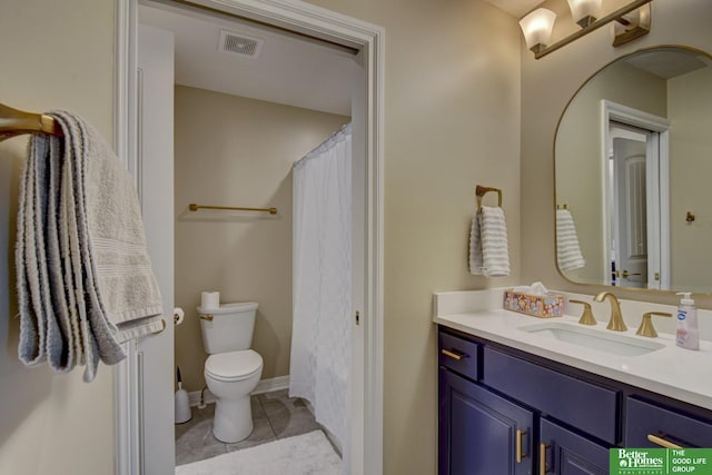 bathroom featuring toilet, vanity, tile patterned floors, and a shower with curtain