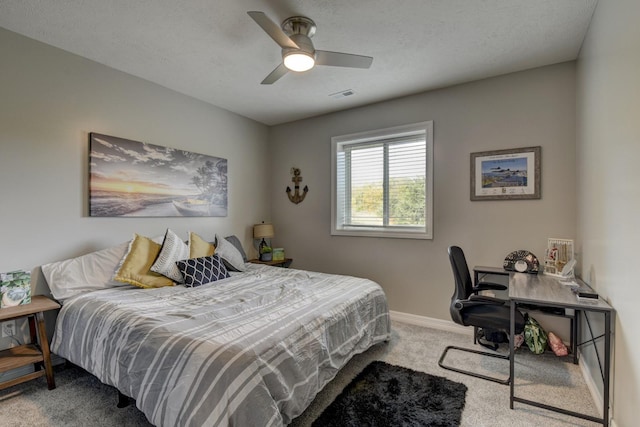 carpeted bedroom featuring baseboards, an office area, and a ceiling fan