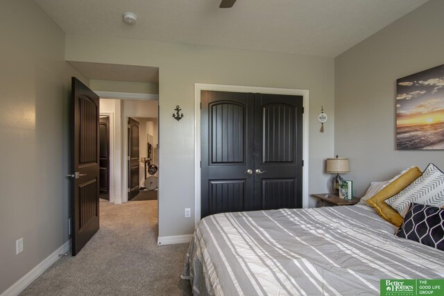 carpeted bedroom with a closet, baseboards, and ceiling fan