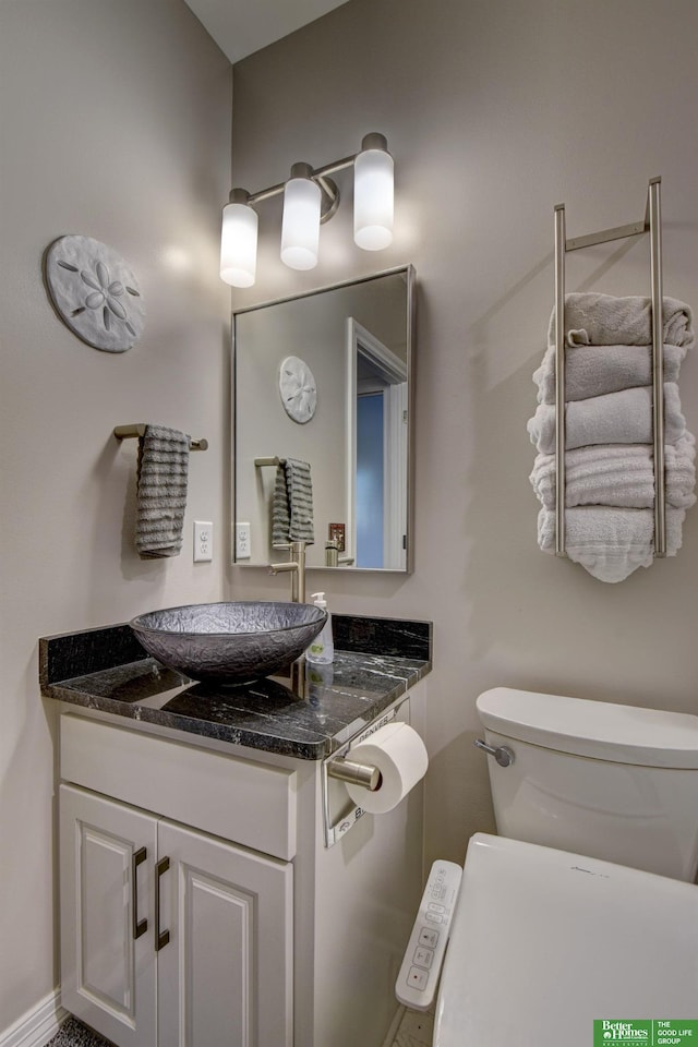 bathroom featuring toilet and vanity