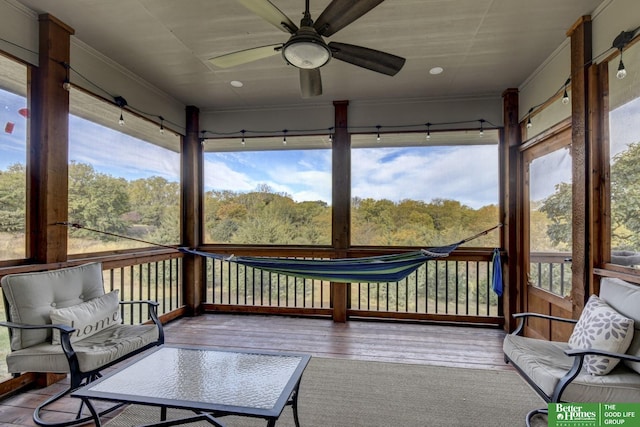 sunroom with a ceiling fan and healthy amount of natural light