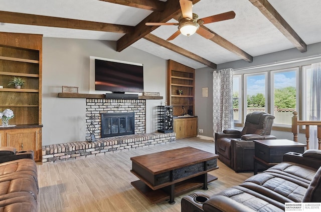 17819 Nicholas Rd, Plattsmouth, NE 68048 - living area featuring wood finished floors, a ceiling fan, baseboards, a fireplace, and built in features