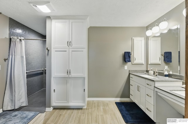 17819 Nicholas Rd, Plattsmouth, NE 68048 - bathroom with wood finished floors, a tile shower, and double vanity
