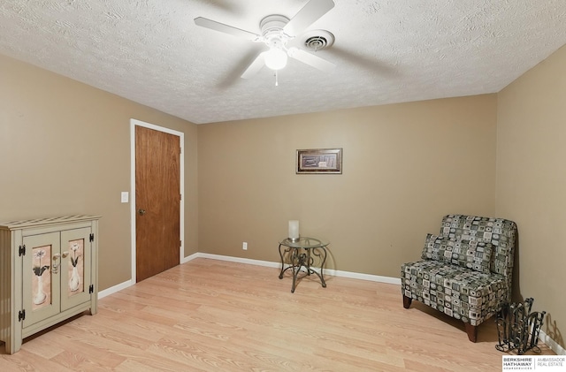17819 Nicholas Rd, Plattsmouth, NE 68048 - sitting room featuring light wood finished floors, a ceiling fan, a textured ceiling, and baseboards