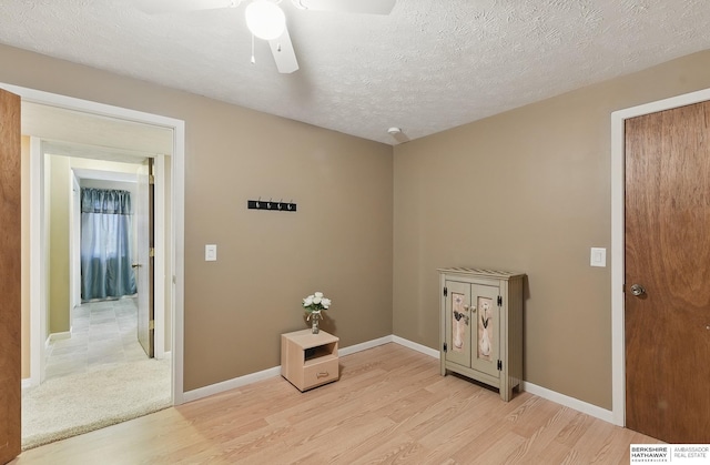 17819 Nicholas Rd, Plattsmouth, NE 68048 - spare room featuring light wood-style flooring, a ceiling fan, baseboards, and a textured ceiling