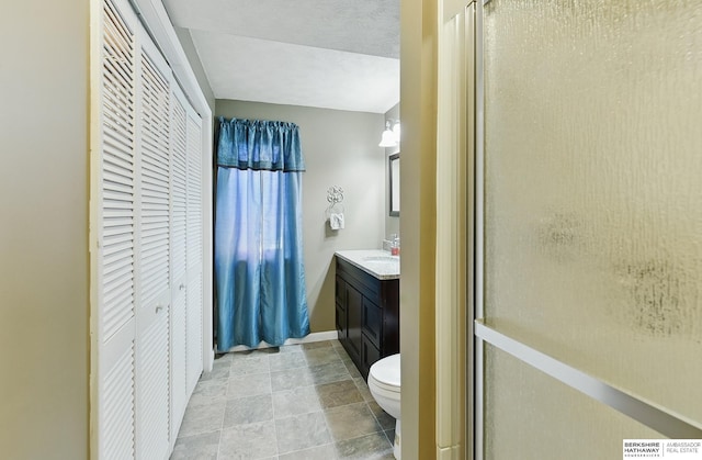 17819 Nicholas Rd, Plattsmouth, NE 68048 - bathroom with vanity, toilet, a shower stall, a closet, and stone finish floors
