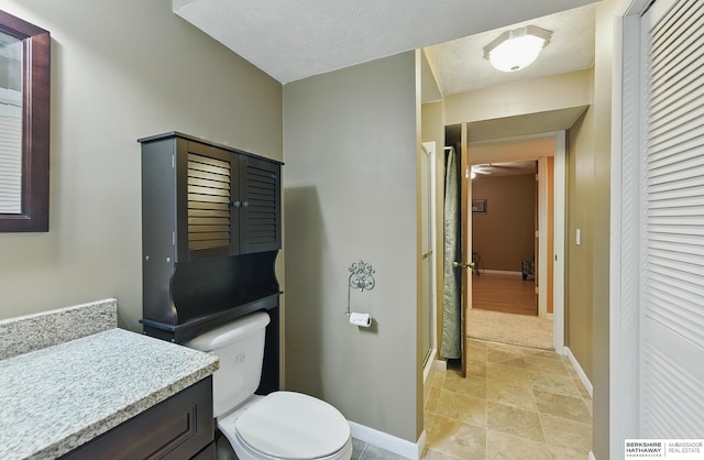 17819 Nicholas Rd, Plattsmouth, NE 68048 - bathroom with toilet, a closet, baseboards, and vanity